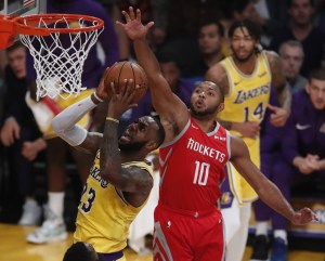 Eric Gordon jumps to block LeBron James at the rim.