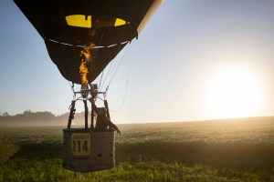 Pilot Cameron Wall launches his hot air balloon over a field