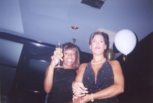 Two Atlanta dancers from the Gold Club strip club posing, one of them holding a champagne glasss