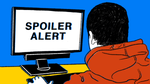 Guy looking at a screen that says SPOILER ALERT