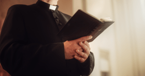 priest holding a bible